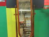 a mirror that is sitting on a stand in a room