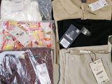 several pairs of men ' s nike golf shirts and pants laid out on a table