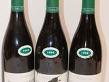 trois bouteilles de vin posées sur une table, l'une à côté de l'autre