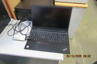 un ordinateur portable posé sur une table blanche