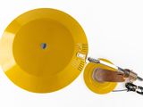 a yellow bowl with a whisk in it on a white surface