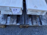 two wooden boxes sitting on a pallet with a person standing next to them