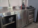 a large stainless steel kitchen with a sink and a stove