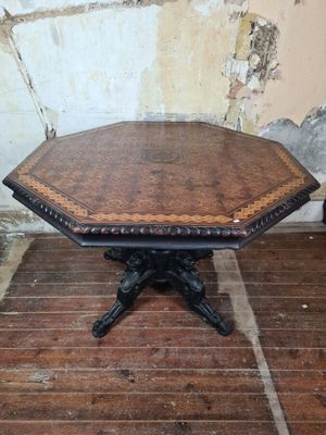 a small table with a wooden top on a wooden floor