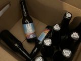 many bottles of beer in a cardboard box on the floor