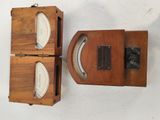 two wooden boxes with a clock on top of them on a white surface