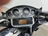 a close up of a motorcycle dashboard with a digital display