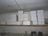 many boxes that are stacked on a shelf in a room