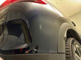 a close up of the rear end of a car in a garage