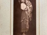 an old picture of a woman holding a child in her arms
