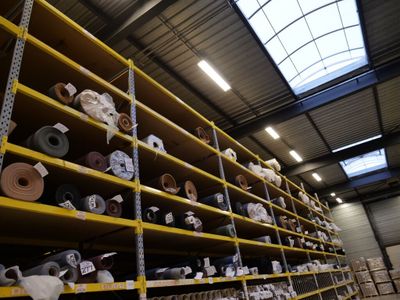 many rolls of toilet paper on the shelves in the warehouse