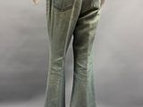 the back view of a mannequin wearing jeans and a brown shirt