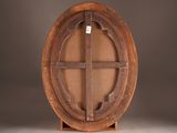 a wooden plate with a cross on it on a stand