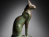 an egyptian bronze statue of a cat on a marble base