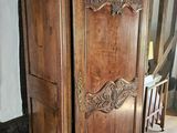 a large wooden cabinet in the middle of a room