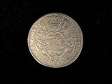 an image of a silver coin on a black background