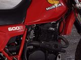 a red motorcycle that is parked in a garage
