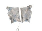 two pieces of cloth with blue and white flowers on a white background