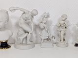 several figurines of different sizes and shapes are lined up on a shelf