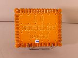 a small orange plaque with a name on it