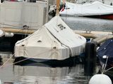 many boats that are docked in the water near a dock