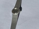 a watch that is laying on a white table