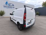 a white van parked in a parking lot next to a building