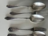 five spoons and two spoons on a white plate