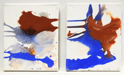 two paintings of different colors and shapes on a white surface
