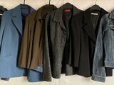 a lot of jackets hanging on a clothes rack