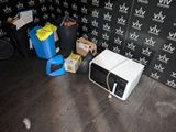 a microwave sitting on the floor in front of a wall