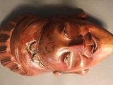a close up of a statue of a man ' s face on a table