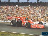 a man driving a race car on a track