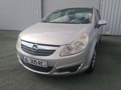 a silver car that is parked in front of a building