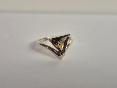 a close up of a silver ring on a white surface