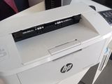 a white printer sitting on top of a white desk
