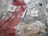 a pile of clothing wrapped in plastic bags on a table