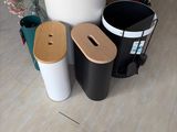 three trash cans sitting next to each other on the floor
