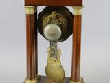 a wooden clock that is on display on a table