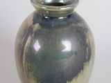 a blue and white vase sitting on a white surface