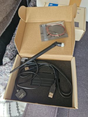 a box with a cable and a charger inside of it