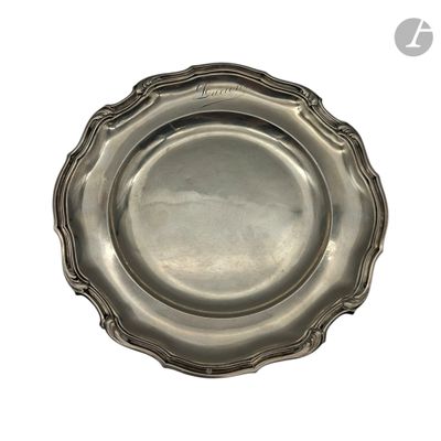 une assiette en argent posée sur une surface blanche