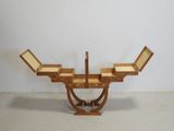 a wooden table with two chairs on it in a room