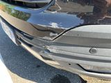a close up of a car ' s front bumper with scratches