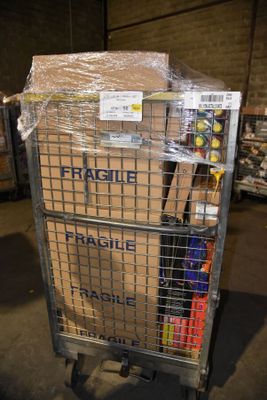 a cart that has many boxes on it in a warehouse