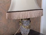 a lamp that is on a table with a doily on it