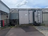 two portable toilets on the side of a building