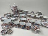 many different types of dishes and cups on the table