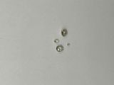 three diamonds are shown on a white surface with a small diamond in the middle