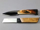 a knife that is laying next to a knife on a table